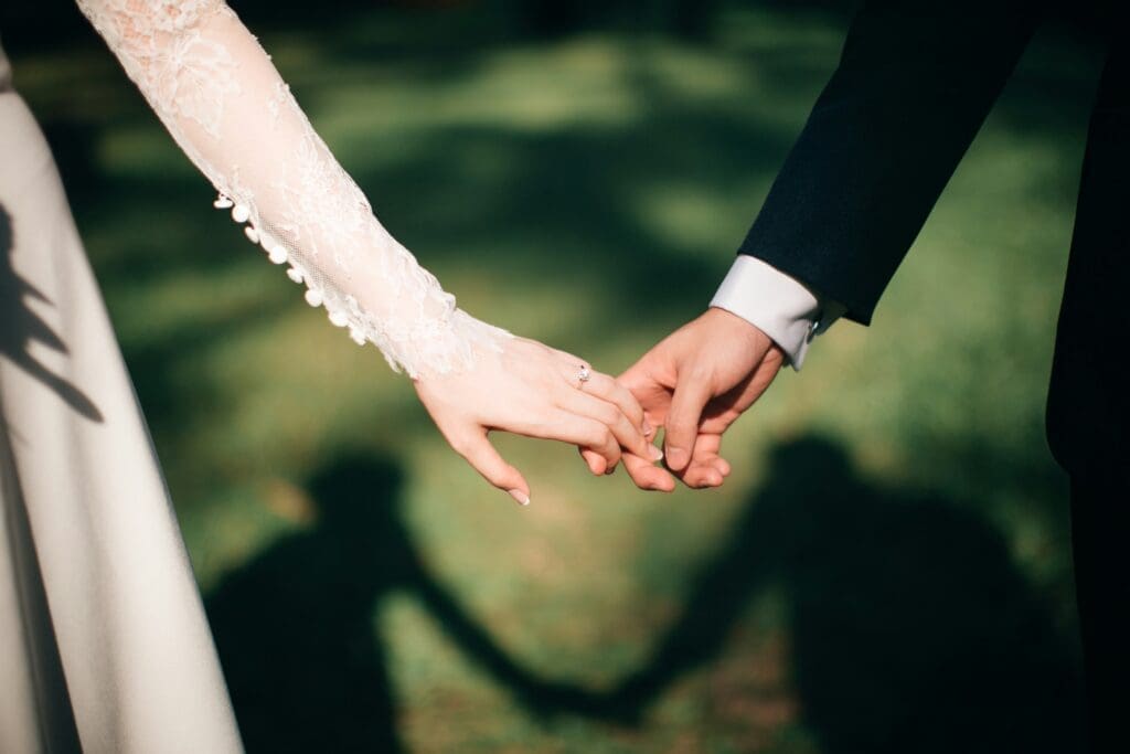 A joyful couple surrounded by loved ones, dancing and celebrating at their wedding reception