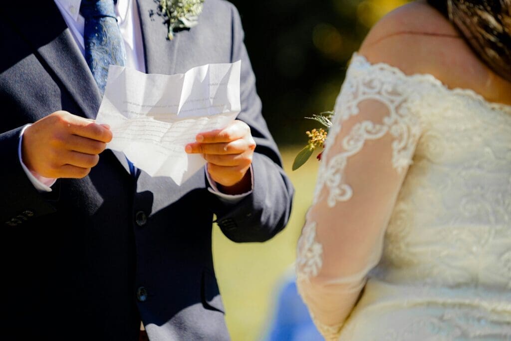A couple exchanging heartfelt vows during their outdoor wedding ceremony