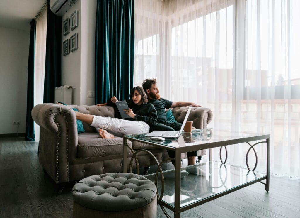 A couple reviewing a long guest list with a mix of excitement and overwhelm